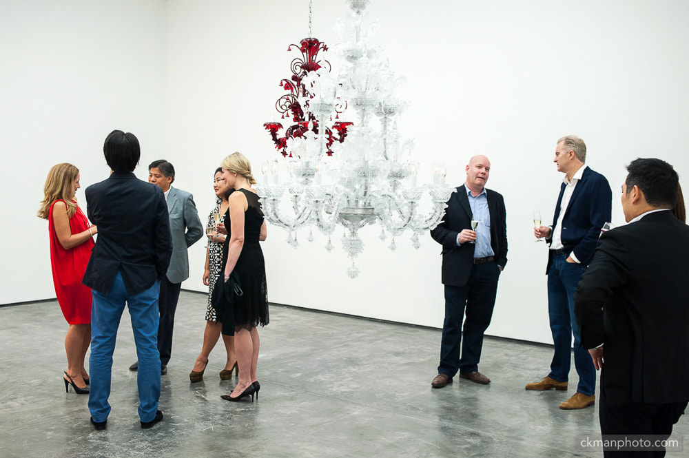White Cube Gallery VIPs mingling. chandelier in the gallery