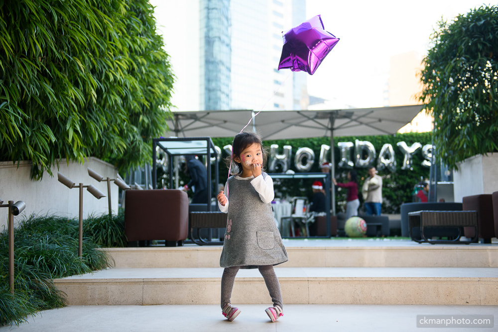 Stylish little girl holding balloon