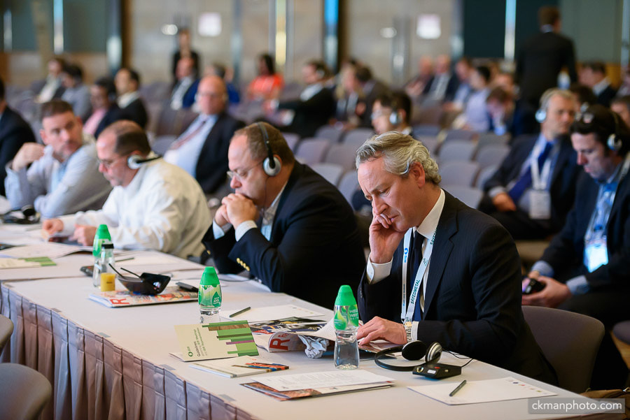 Guests in the conference with simultaneous translation headphones.