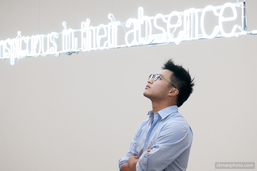 Young asian man appreciating an artwork of neon lights